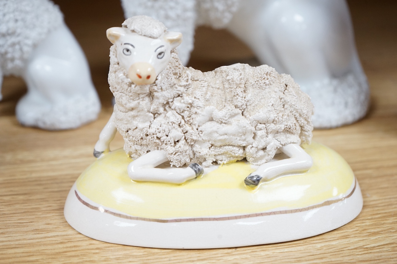 A pair of Continental porcelain models of Poodles a similar smaller pair and a pair of late Staffordshire sheep. Large poodles 23cm high. Condition - one leg on large Poodle broken and reglued